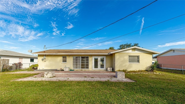 back of house with a yard, central AC unit, and a patio area