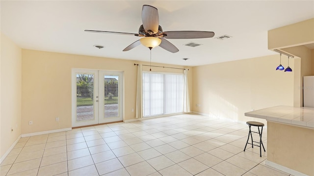 unfurnished room with french doors, ceiling fan, and light tile patterned floors