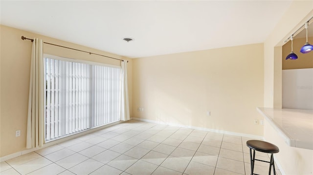 spare room featuring light tile patterned floors