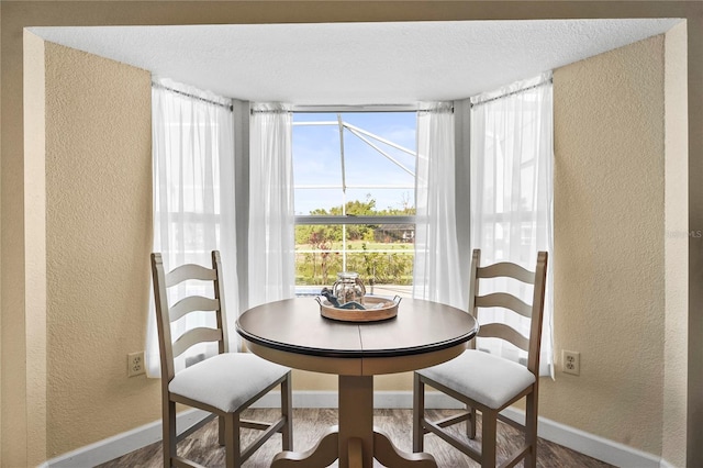 dining space featuring a textured ceiling