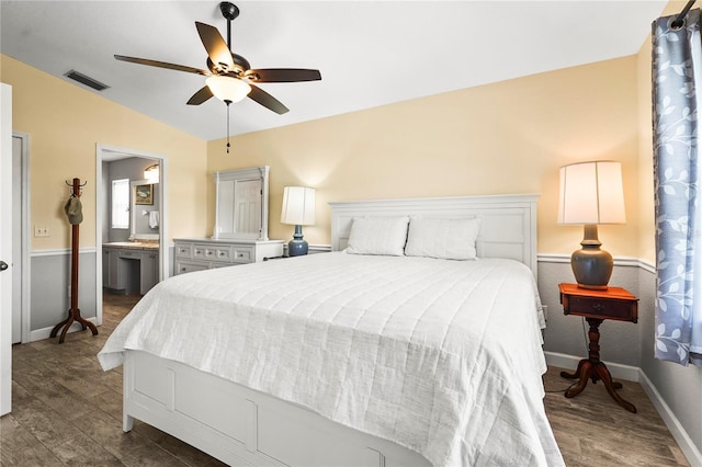 bedroom featuring lofted ceiling, dark hardwood / wood-style flooring, ceiling fan, and ensuite bathroom