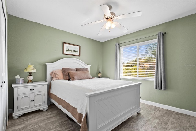 bedroom with ceiling fan and hardwood / wood-style floors