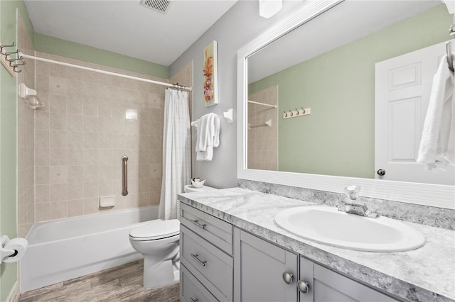 full bathroom with vanity, hardwood / wood-style flooring, shower / bath combination with curtain, and toilet