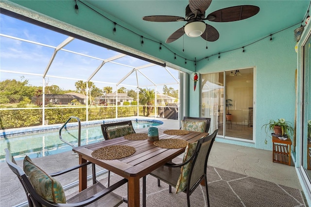 view of patio featuring ceiling fan and a lanai