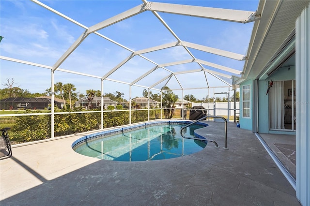 view of pool with a lanai and a patio