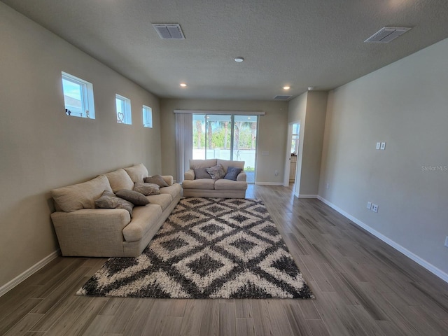 living room featuring hardwood / wood-style flooring and a textured ceiling