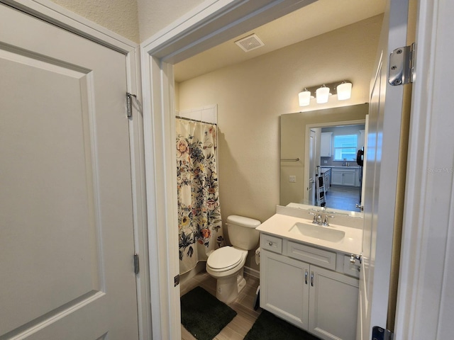 bathroom with a shower with curtain, vanity, and toilet