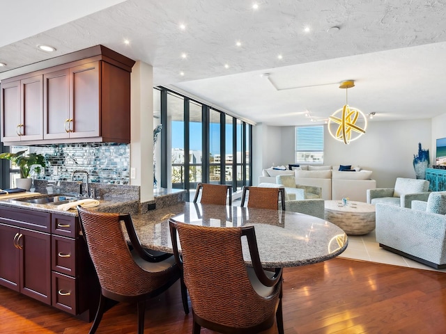 dining room with dark hardwood / wood-style flooring and sink