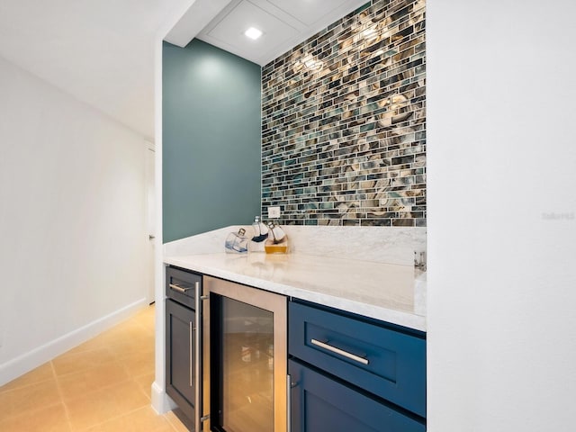 bar featuring backsplash and beverage cooler