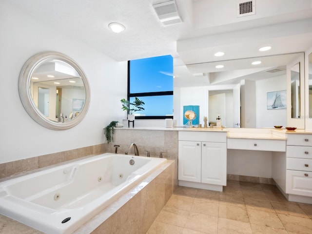 bathroom featuring vanity and tiled bath