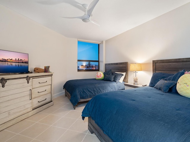 bedroom with ceiling fan and light tile patterned floors