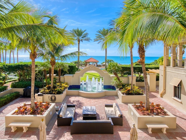 view of patio featuring a water view and outdoor lounge area