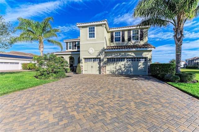 mediterranean / spanish-style house with a garage and a front yard