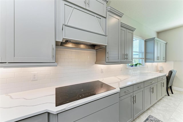 kitchen with gray cabinets and light stone counters