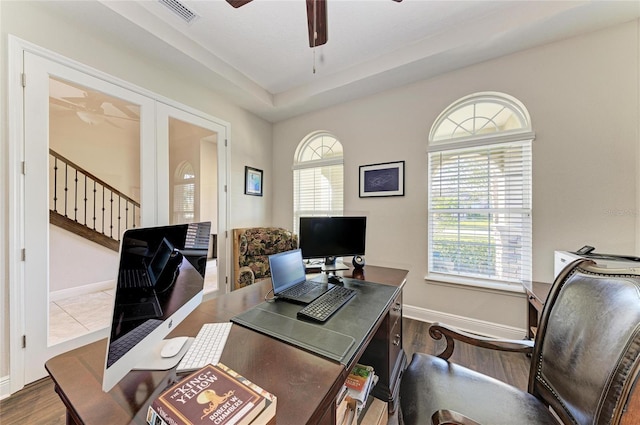 home office featuring dark wood-type flooring and ceiling fan