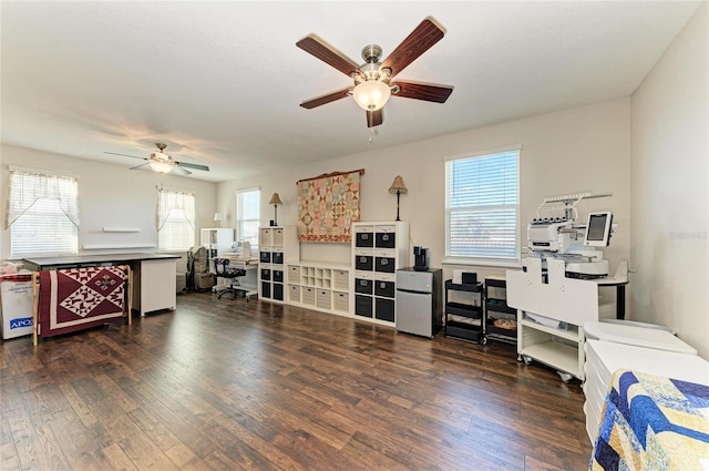 living room featuring dark wood-type flooring and ceiling fan