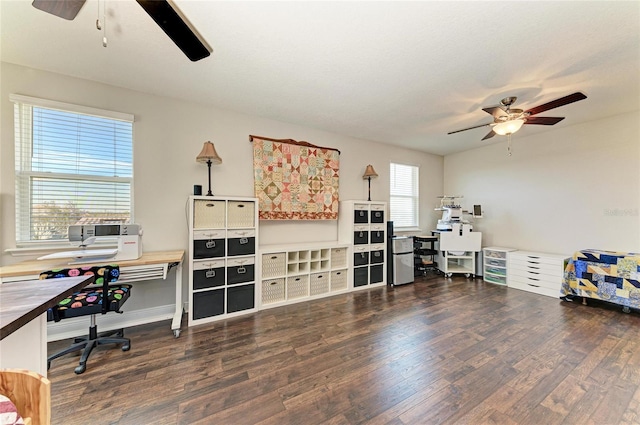 home office with dark wood-type flooring and ceiling fan