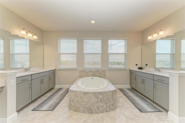 bathroom with vanity and tiled bath