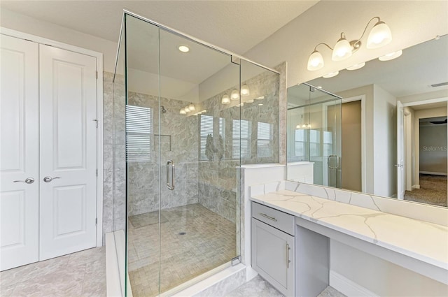 bathroom featuring walk in shower and vanity