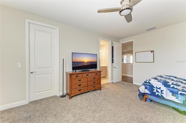 carpeted bedroom featuring connected bathroom and ceiling fan