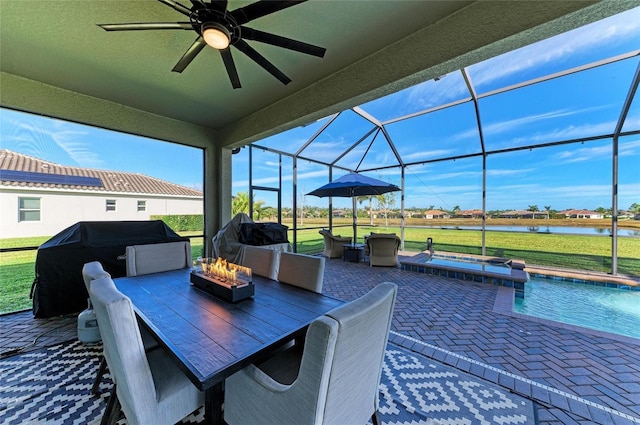 view of patio / terrace with a water view, glass enclosure, a swimming pool with hot tub, an outdoor fire pit, and a grill