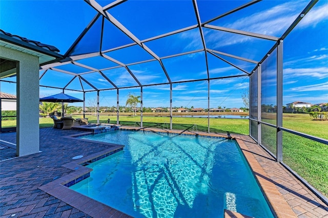 view of swimming pool with a lawn, an in ground hot tub, glass enclosure, a water view, and a patio area