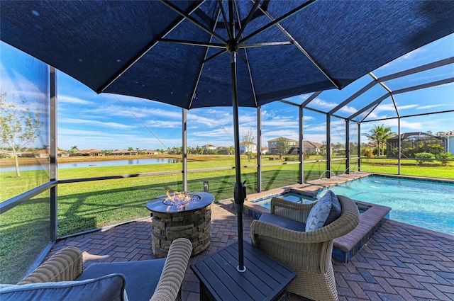 view of patio / terrace with a water view, a swimming pool with hot tub, a lanai, and a fire pit