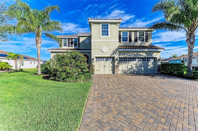 mediterranean / spanish-style home with a garage and a front yard