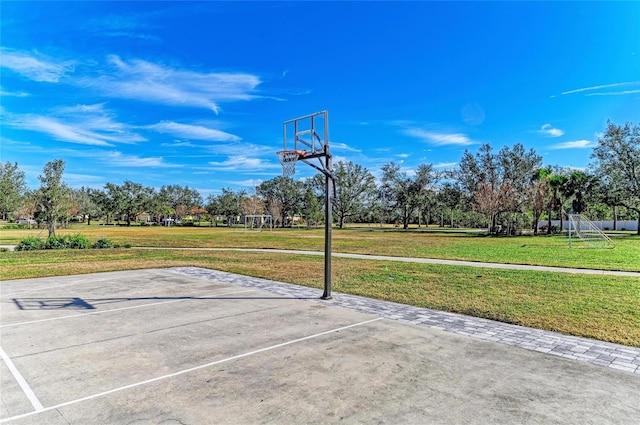 view of sport court with a lawn