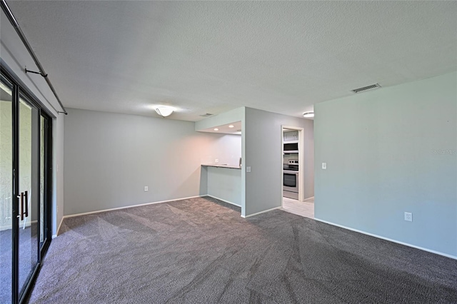 basement with a textured ceiling and carpet flooring