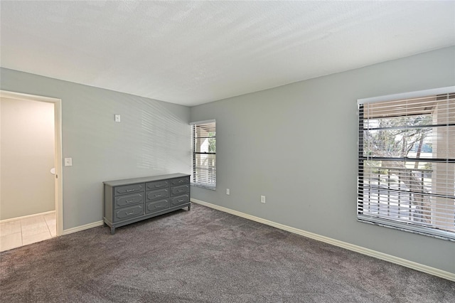 carpeted spare room with a textured ceiling