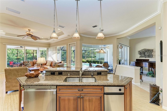 7215 Treymore Ct, Sarasota, FL 34243 - kitchen featuring pendant lighting, sink, stainless steel dishwasher, light stone counters, and a raised ceiling