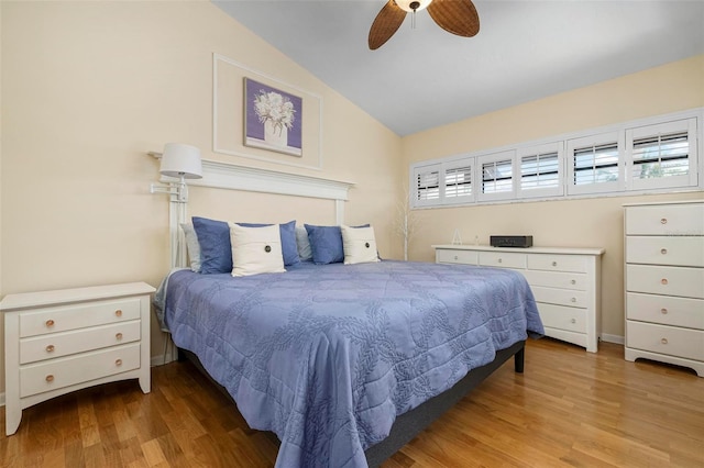 bedroom with lofted ceiling, light hardwood / wood-style floors, and ceiling fan