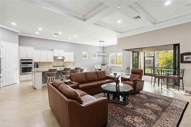 living room with coffered ceiling, sink, light tile patterned floors, ornamental molding, and beam ceiling