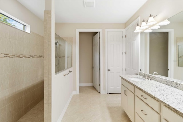 bathroom featuring vanity and a tile shower