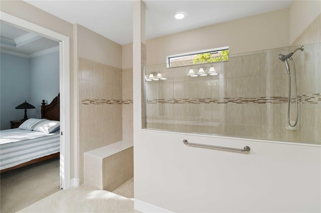 bathroom featuring tile patterned flooring and tiled shower