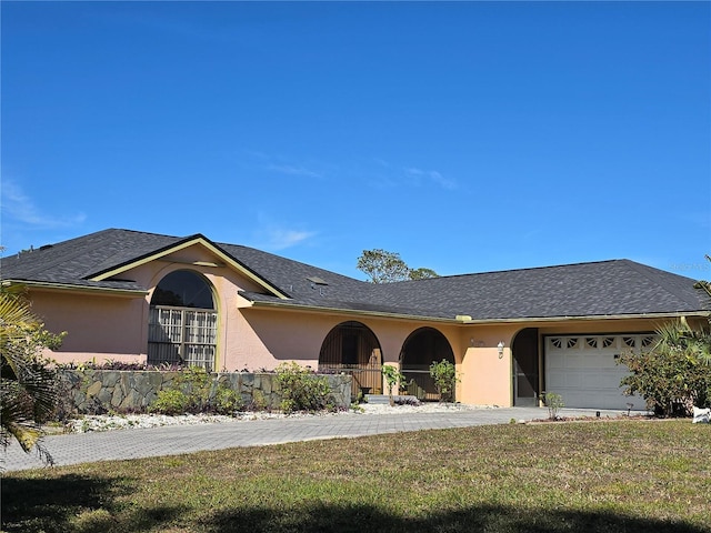 single story home with a garage and a front yard