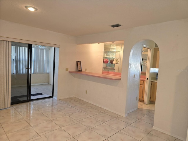 unfurnished room featuring light tile patterned floors