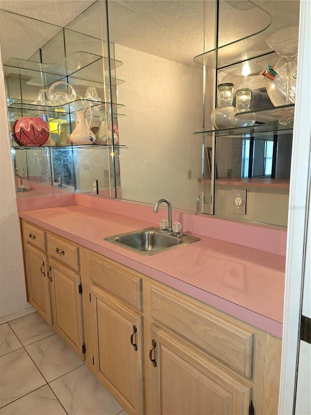 bar featuring light brown cabinetry and sink