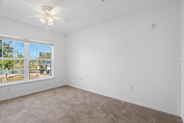 empty room with ceiling fan and carpet