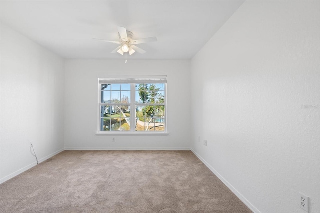 empty room featuring light carpet and ceiling fan