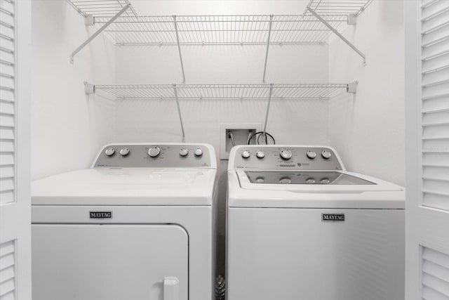 clothes washing area featuring separate washer and dryer