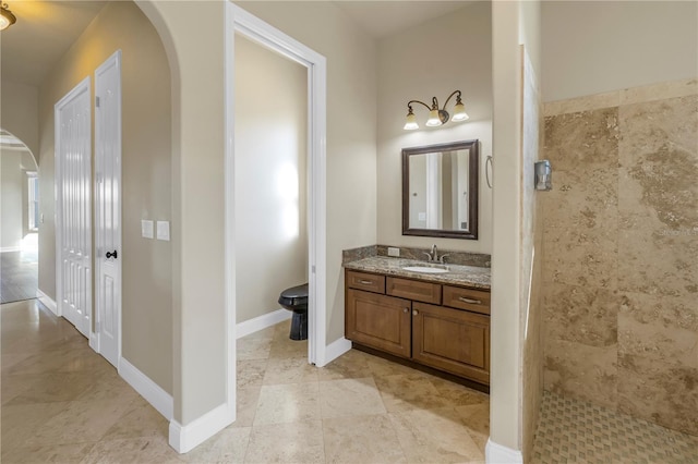 bathroom featuring vanity and tiled shower