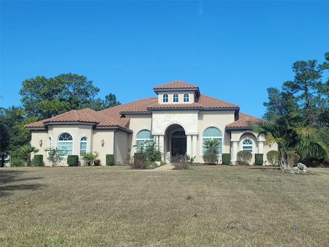 mediterranean / spanish-style home with a front lawn