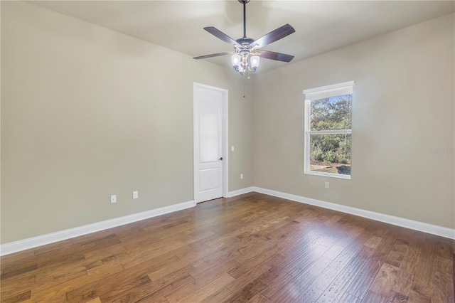 empty room with ceiling fan and dark hardwood / wood-style floors