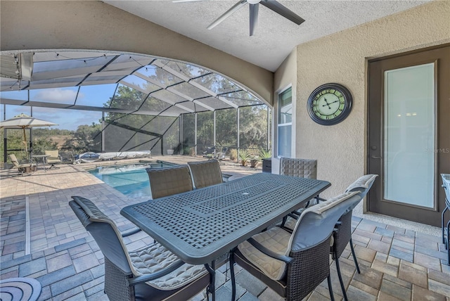 view of patio featuring a pool with hot tub, ceiling fan, and glass enclosure