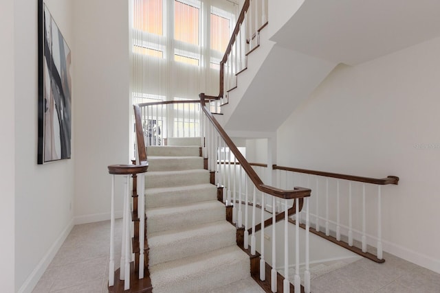 stairs with tile patterned flooring and a wealth of natural light