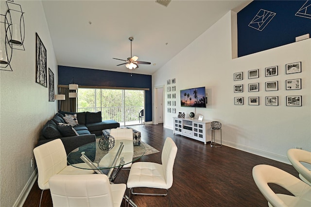 dining room with ceiling fan, dark hardwood / wood-style floors, and high vaulted ceiling