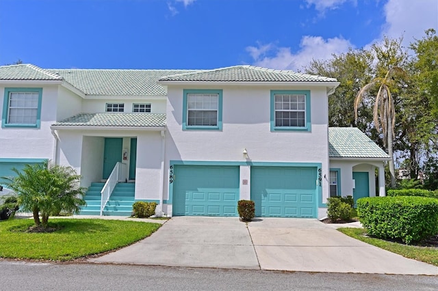 6589 Fairway Gardens Dr Unit 202, Bradenton, FL 34203 - view of front of house with concrete driveway, a tiled roof, a garage, and stucco siding