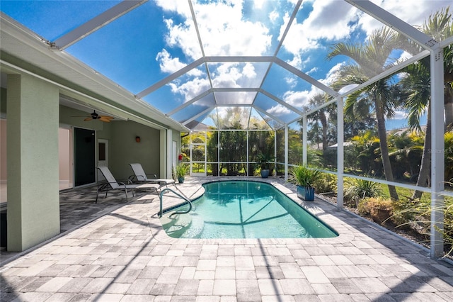 view of pool with a patio, a lanai, and ceiling fan